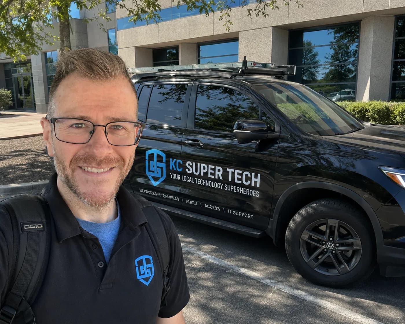 Jon beside the branded KC Super Tech service vehicle at a client site